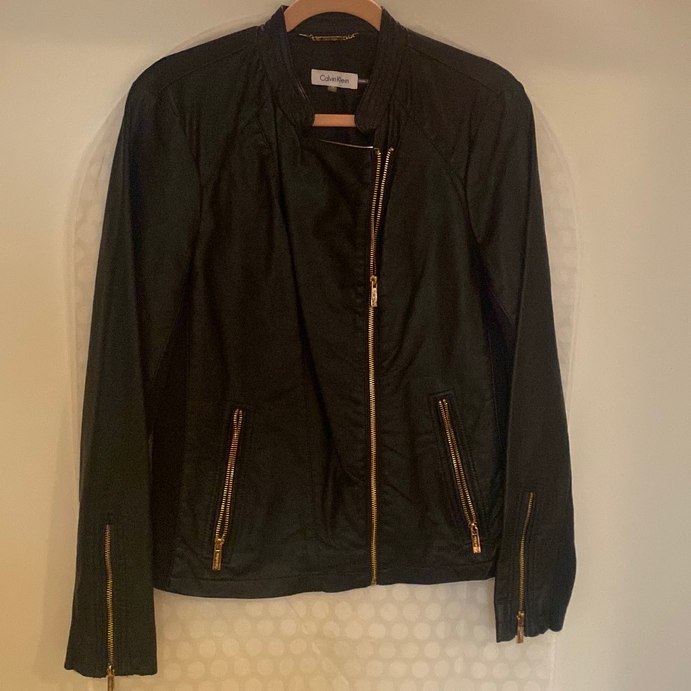 Calvin Klein leather jacket with sides of stretch , size M fits good on Large